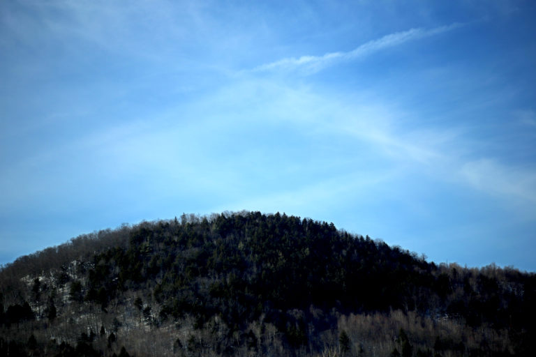 Hill Under Pale Blue Sky