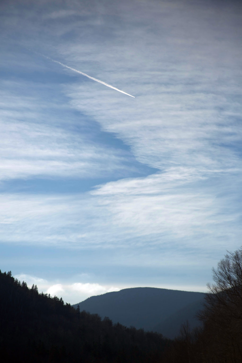 Jet Trail Across a Cloudy Sky