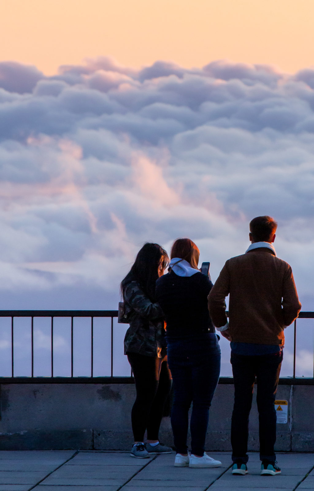 People Standing Above Clouds
