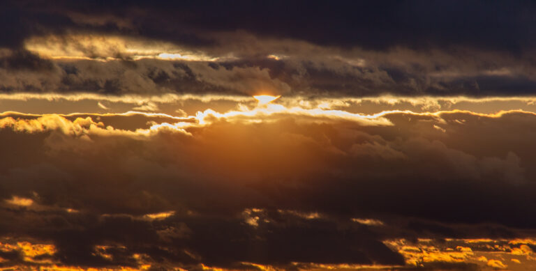 Sunset Lowering Through Clouds