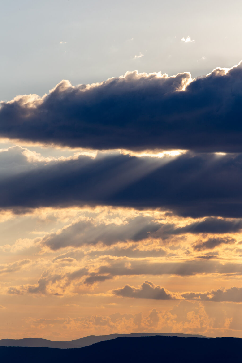 Clouds and Sunlight Over Mountains