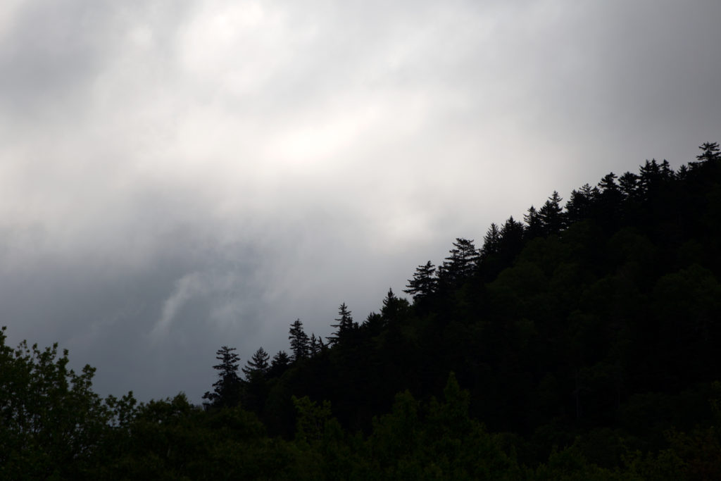 Hill Silhouette Against Cloudy Sky