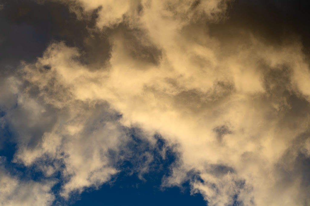 Sepia-Tone Clouds Against Blue Sky