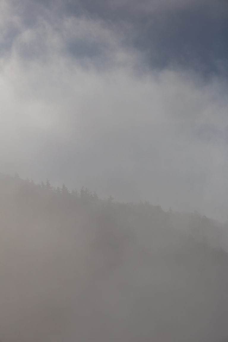 Mountainside Silhouette Through Thick Fog