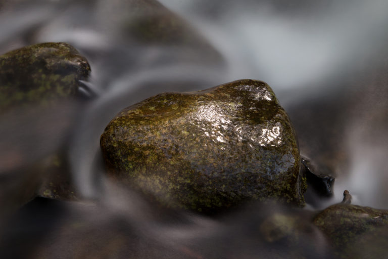 Swirling Water Around a Small Rock