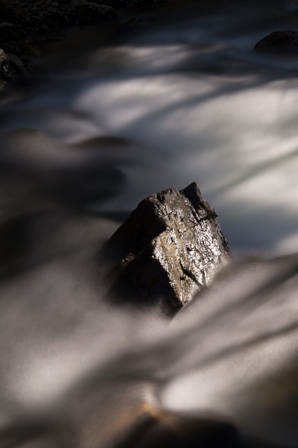 Rock Protruding From Rushing Stream