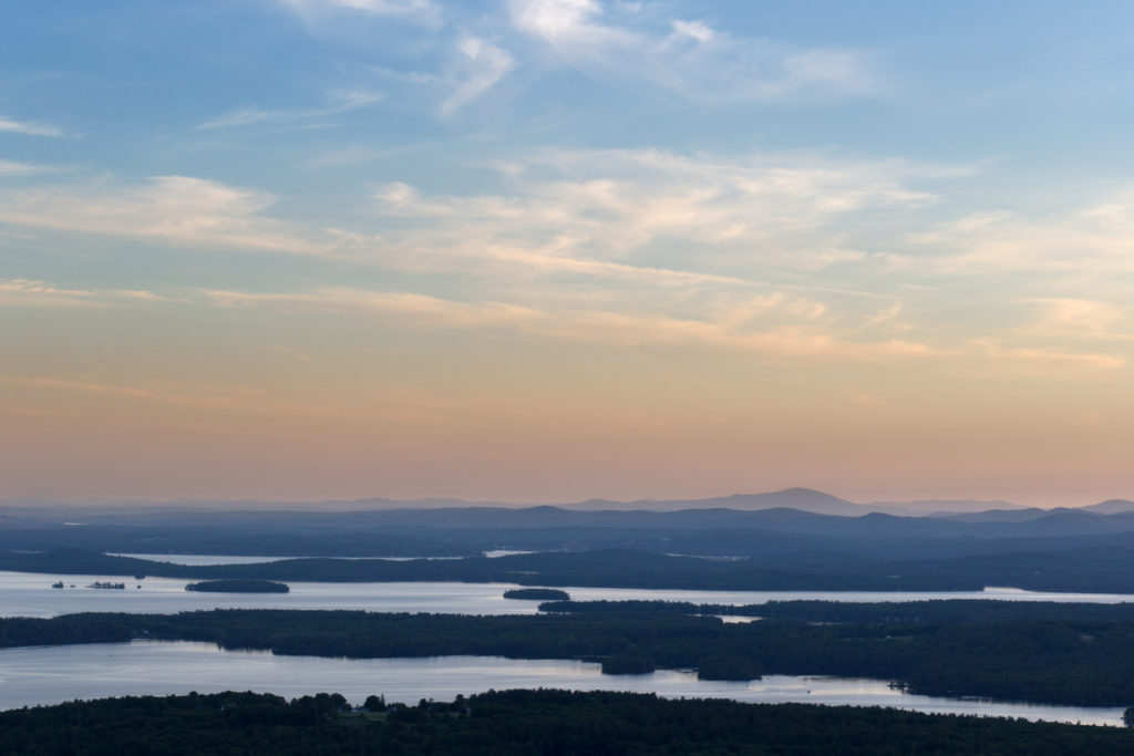 Hazy Sunset Over Lakes and Mountains
