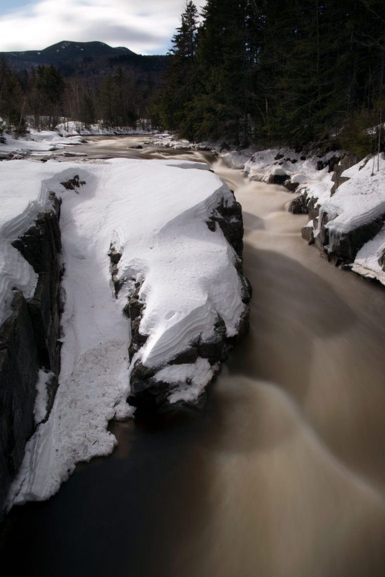 River Moving Through Snow-Covered Rocks